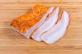 Partly sliced boiled smoked pork belly on wooden cutting board