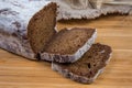 Partly sliced brown bread on wooden surface close-up Royalty Free Stock Photo