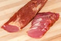 Partly sliced dry-cured pork tenderloin, fragment close-up Royalty Free Stock Photo