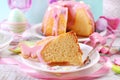 Partly sliced easter ring cake with pink icing