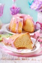 Partly sliced easter ring cake with pink icing Royalty Free Stock Photo