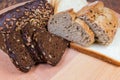 Partly sliced various bread on the wooden surface close-up Royalty Free Stock Photo