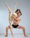 Partners acrobats posing against a white wall. Young duet of ballet dancers perform support with twine in the studio. A