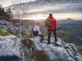 Nature photographers with big camera on tripod on summit