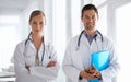 Partners in health. Portrait of two smiling doctors standing in a hospital. Royalty Free Stock Photo