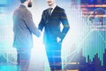 Partners shaking hands, lines of code and graphs
