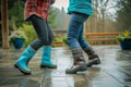 partners in waterproof boots do a jitterbug on a wet patio Royalty Free Stock Photo