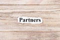 Partners of the word on paper. concept. Words of Partner on a wooden background