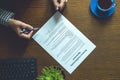 Partnership agreement business document signed by a person on the table in the office