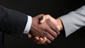 Partnership concept. Closeup of two businessmen shaking hands over black background Royalty Free Stock Photo