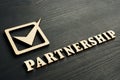 Partnership concept. Wooden letters on a desk