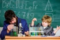 A Partnership in Discovery. Wisdom. Back to school. Flask in scientist hand with Test tubes. son and father at school