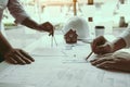 The partnership engineering man or co-workers working on a project and discussing together with looking at blueprint paperwork Royalty Free Stock Photo