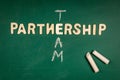 Partnership and Team concept. Letters of the alphabet on a green chalk board Royalty Free Stock Photo