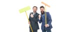 Partnership and teamwork. mature bearded men in suit hold householding mop. clean slate. businessmen clear wall to white