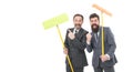 Partnership and teamwork. mature bearded men in suit hold householding mop. clean slate. businessmen clear wall to white