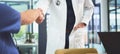 This partnership will be for the good of the patient. Closeup shot of doctors shaking hands during a meeting in a Royalty Free Stock Photo