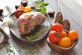 Partridge fresh wild bird with colorful tomatoes on dark rustic table