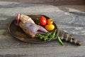 Partridge fresh bird on wooden rustic plate with tomatoes