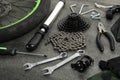 Parts of bicycle and tools on grey background, closeup Royalty Free Stock Photo