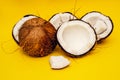 Parts of coconut on a colored background. Close up. Fresh ripe coconut broken into pieces.