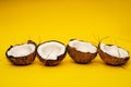 Parts of coconut on a colored background. Close up. Fresh ripe coconut broken into pieces.