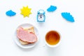 Parts of day. Morning. Time for breakfast. Tea, sandwich near alarm clock, sun and clouds cutout on white background top Royalty Free Stock Photo