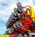Parts and mechanisms of agricultural machinery on background of blue sky. Close-up of seeder