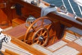 Detail photos of a sailing yacht, steering wheel, teak deck and compass