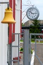 Parts of the old railway station. Retro clock and bell on the train platform