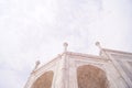 Some parts of arches and pillars of Taj Mahal on sky background, Agra, India