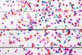 Party background. Party colorful confetti on white wooden background. Royalty Free Stock Photo