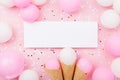 Party or birthday mockup with paper card, pastel balloons and confetti on pink table top view. Flat lay composition.