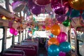 party bus interior with balloons, streamers, and revelers