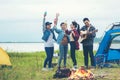 Party Camping.  Group asian family and friends travel enjoy party and roasted sausages relax in vacations. Campfire at touristic c Royalty Free Stock Photo