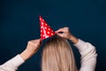 Party and celebration.Woman holding paper red hat with stars on Royalty Free Stock Photo