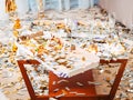 Party chaos table leftovers champagne confetti
