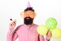 Party concept. Hipster in giant sunglasses celebrating birthday. Guy in party hat with party horn celebrates. Man with Royalty Free Stock Photo
