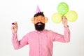 Party concept. Hipster in giant sunglasses celebrating birthday. Man with beard and mustache on happy face holds air Royalty Free Stock Photo