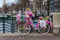 Party decorated bicycle in Amsterdam by a canal at sunset