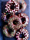 Chocolate glazed donuts garnished with sugar beads