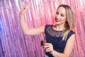 Party, drinks, holidays and celebration concept - smiling woman in evening dress with glass of sparkling wine over shiny Royalty Free Stock Photo