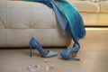 Party female outfit collection blue dress shoes accessories jewelry on beige sofa on floor in the interior. After holiday or