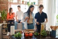 Party of four friends cooking home pizza in kitchen Royalty Free Stock Photo