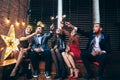 Party with friends. Happy young people carrying sparklers and ha Royalty Free Stock Photo