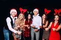 Party with friends. They love Christmas. Group of cheerful young people carrying sparklers and champagne flutes dancing Royalty Free Stock Photo