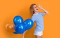 party girl with balloon in sunglasses. surprised girl hold party balloons in studio.