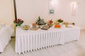 Party hall interior. Assortment of fresh pastry on table in catering buffet Royalty Free Stock Photo