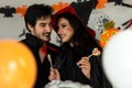 Party Halloween holiday. Young couple party and celebrate with Halloween pumpkin and cocktails