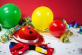 Party hat with bow, balloons and streamers Royalty Free Stock Photo